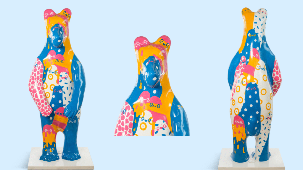An image which shows the front, back and close up head of a bear sculpture designed by Sian Ellis for the Bears of Sheffield. The bear features an an all-over colourful design in orange, pink, blue and white.