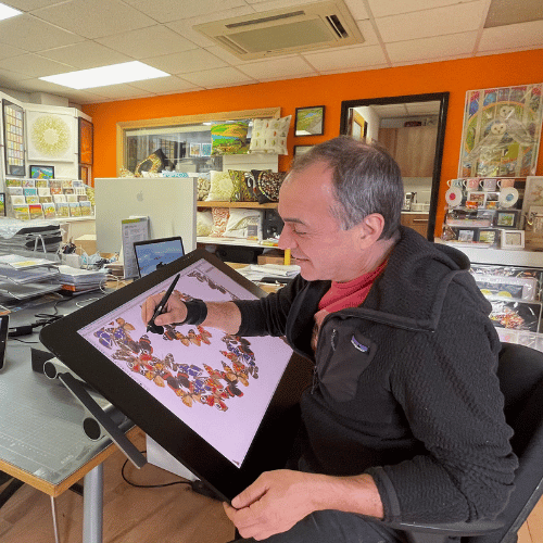 A person works on a piece of art. They are shot from side on, and are in a studio environment.