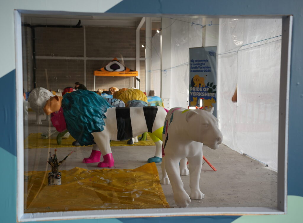 A window into the painting space, showing lions coming to life