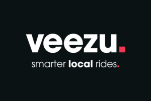 A black background with a text text logo that reads veezu: smarter local rides.