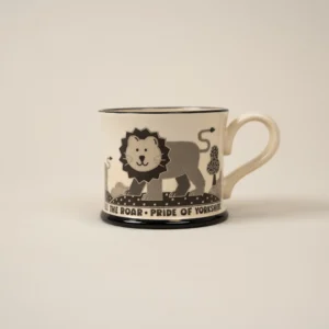A black and white, large mug with a cartoon lion it that reads PRIDE OF YORKSHIRE.