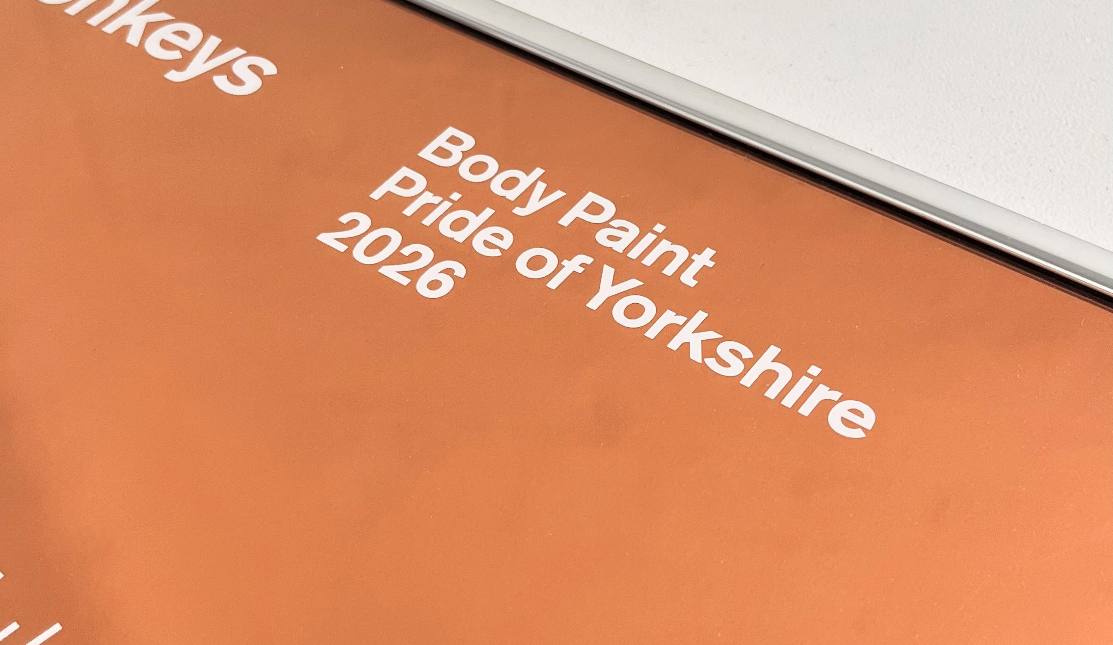 A close-up of a Pride of Yorkshire artprint. It's shiny, copper in colour and says 'Body Paint', 'Pride of Yorkshire 2026'